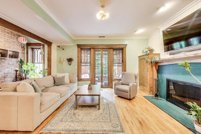 4611 N Magnolia Ave Unit 2, Chicago, IL 60640 - living room with a glass covered fireplace, wood finished floors, and crown molding