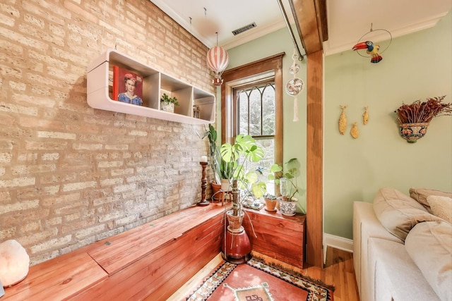 4611 N Magnolia Ave Unit 2, Chicago, IL 60640 - detailed view of brick wall, crown molding, and wood finished floors