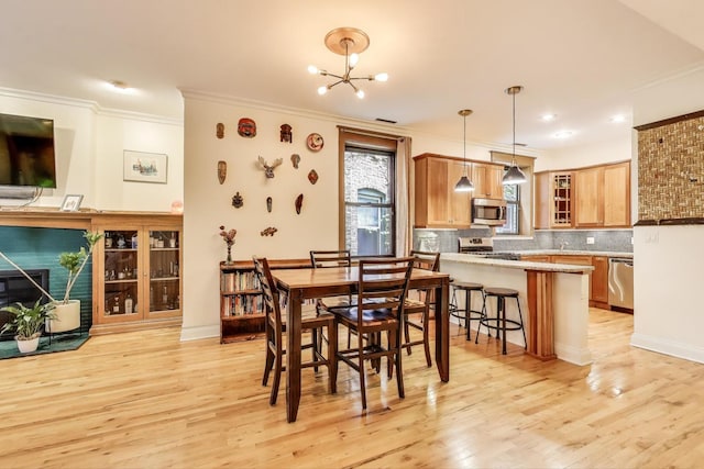4611 N Magnolia Ave Unit 2, Chicago, IL 60640 - dining area featuring ornamental molding, light wood finished floors, a chandelier, and recessed lighting