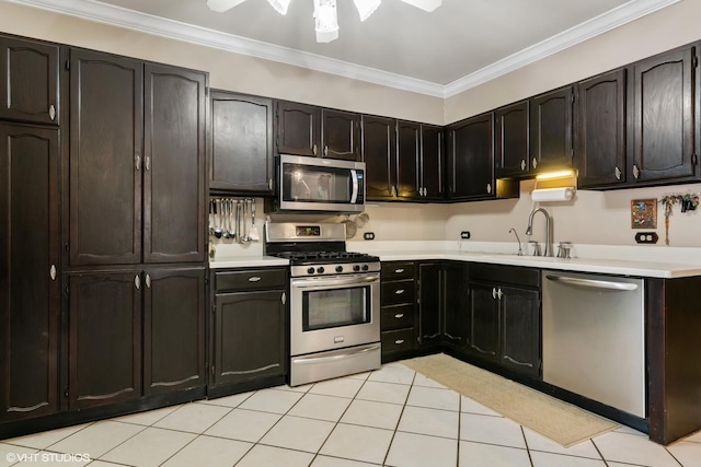3432 S Union Ave, Chicago, IL 60616 - kitchen with stainless steel appliances, crown molding, light tile patterned floors, and light countertops