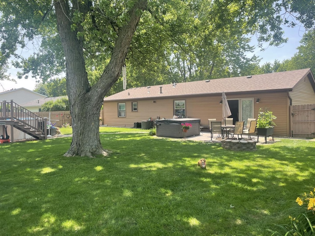 808 Heather Dr, Bourbonnais, IL 60914 - back of house with a hot tub, a patio area, and stairs