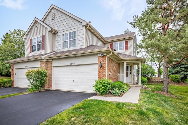 10750 Cape Cod Ln, Huntley, IL 60142 - view of front of home with driveway, a garage, brick siding, a front lawn, and a shingled roof
