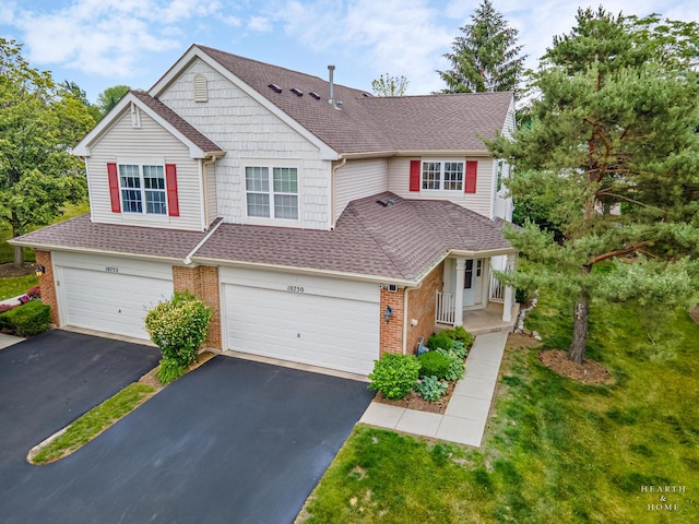 10750 Cape Cod Ln, Huntley, IL 60142 - view of front of house with brick siding, driveway, a shingled roof, a garage, and a porch