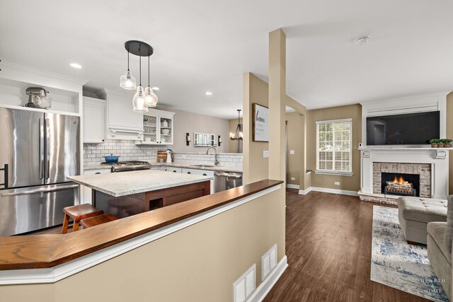 10750 Cape Cod Ln, Huntley, IL 60142 - kitchen with appliances with stainless steel finishes, backsplash, dark wood-type flooring, open floor plan, and plenty of natural light