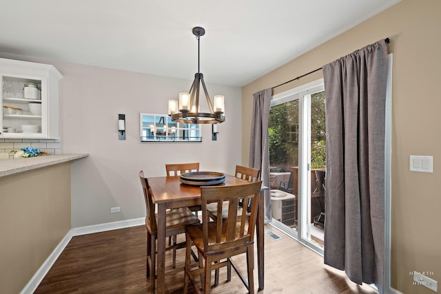 10750 Cape Cod Ln, Huntley, IL 60142 - dining room with a chandelier and wood finished floors