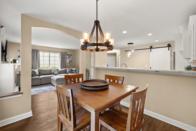 10750 Cape Cod Ln, Huntley, IL 60142 - dining room with a chandelier, a barn door, dark wood finished floors, and recessed lighting