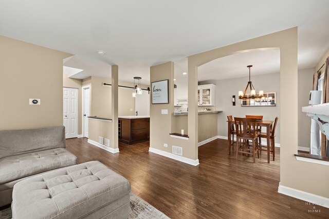 10750 Cape Cod Ln, Huntley, IL 60142 - living area with a chandelier, dark wood-style flooring, and arched walkways