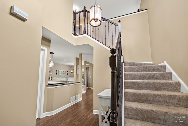 10750 Cape Cod Ln, Huntley, IL 60142 - stairway featuring wood finished floors and a chandelier