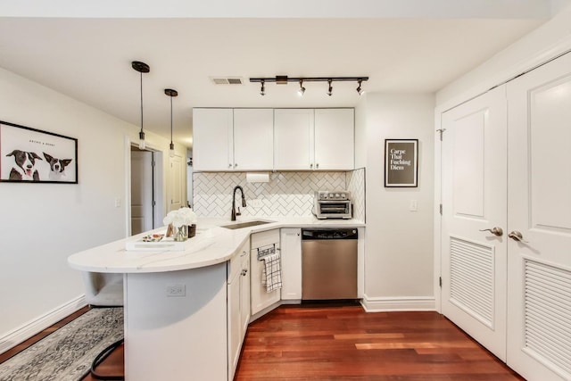 1918 W Cullom Ave Unit 202, Chicago, IL 60613 - kitchen featuring dishwasher, a peninsula, dark wood finished floors, decorative backsplash, and a breakfast bar area