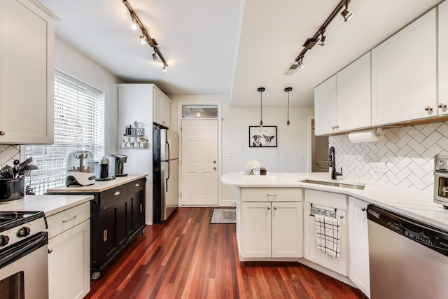 1918 W Cullom Ave Unit 202, Chicago, IL 60613 - kitchen with appliances with stainless steel finishes, track lighting, a peninsula, white cabinetry, and decorative backsplash