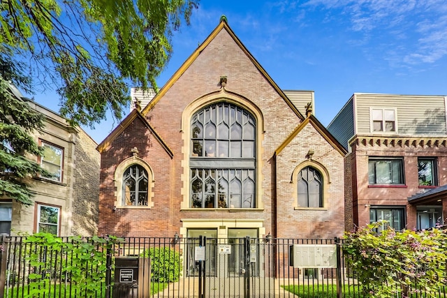 1847 N Kedzie Ave Unit 1N, Chicago, IL 60647 - view of front of house featuring brick siding, a fenced front yard, and a gate