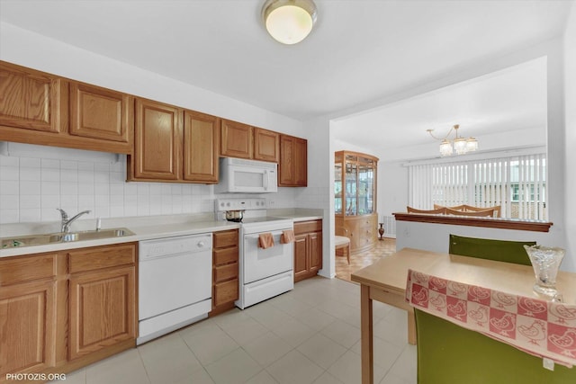 4838 Howard St Unit 301, Skokie, IL 60077 - kitchen with white appliances, light countertops, backsplash, and brown cabinetry