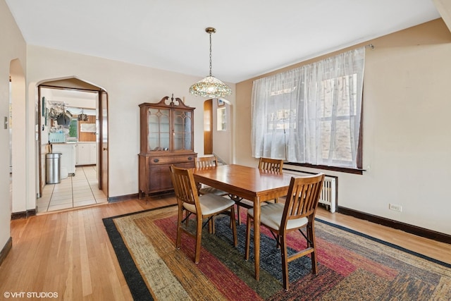 6321 N Merrimac Ave, Chicago, IL 60646 - dining space with arched walkways, light wood finished floors, and radiator
