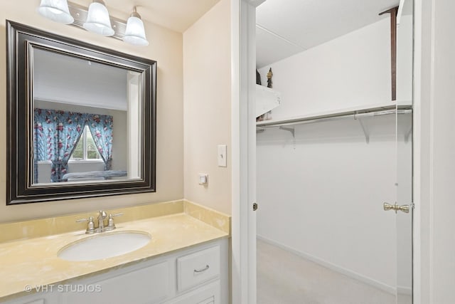 25 Algonquin Trl Unit 1, Indian Head Park, IL 60525 - bathroom featuring vanity and a walk in closet