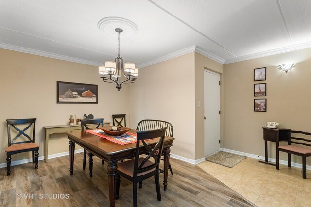 25 Algonquin Trl Unit 1, Indian Head Park, IL 60525 - dining area featuring a chandelier, ornamental molding, and light wood-type flooring
