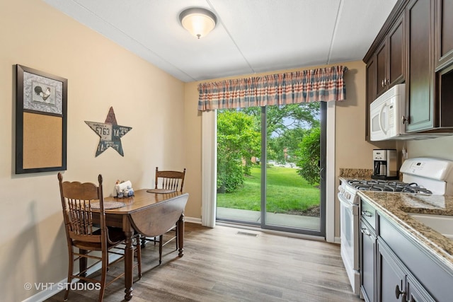 25 Algonquin Trl Unit 1, Indian Head Park, IL 60525 - dining room featuring baseboards and light wood finished floors