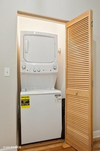 221 E Cullerton St Unit 314, Chicago, IL 60616 - washroom with estacked washer and dryer and light wood-type flooring