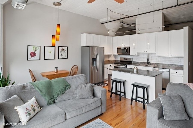221 E Cullerton St Unit 314, Chicago, IL 60616 - living room with light wood-type flooring, a ceiling fan, and high vaulted ceiling