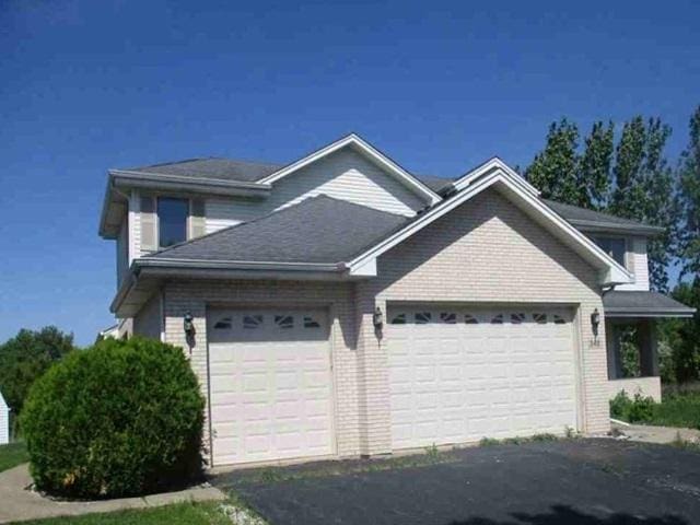 340 Maryview Ct, Matteson, IL 60443 - view of property exterior with an attached garage, brick siding, and asphalt driveway