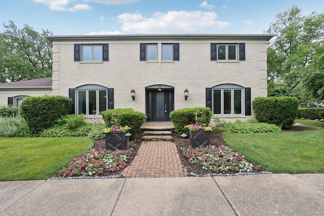 102 E Adelia St, Elmhurst, IL 60126 - colonial house featuring brick siding and a front lawn