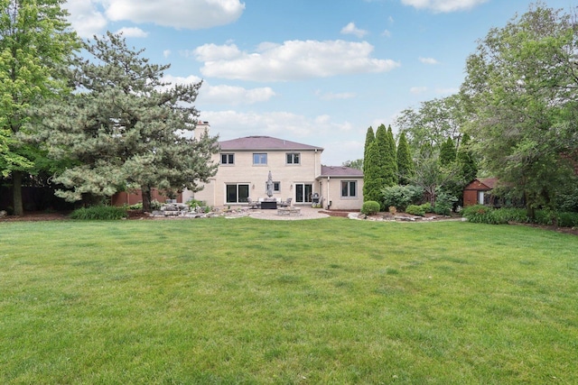 102 E Adelia St, Elmhurst, IL 60126 - rear view of house with a patio, a yard, and a chimney