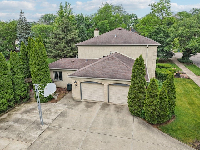 102 E Adelia St, Elmhurst, IL 60126 - view of side of home with brick siding, concrete driveway, a shingled roof, and an attached garage