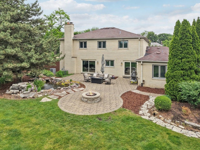 102 E Adelia St, Elmhurst, IL 60126 - back of house with an outdoor living space with a fire pit, a patio, a lawn, a chimney, and brick siding