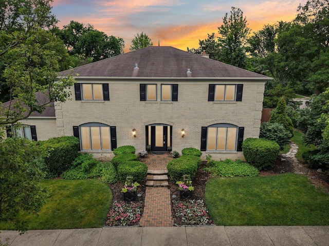 102 E Adelia St, Elmhurst, IL 60126 - colonial home with brick siding, a front yard, a chimney, and roof with shingles