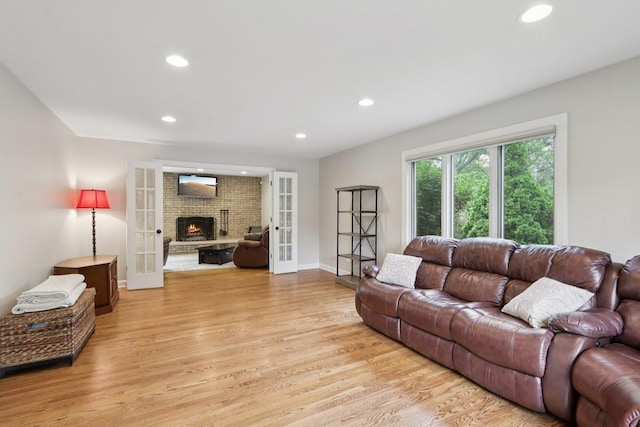 102 E Adelia St, Elmhurst, IL 60126 - living room with light wood finished floors, a fireplace, recessed lighting, and french doors