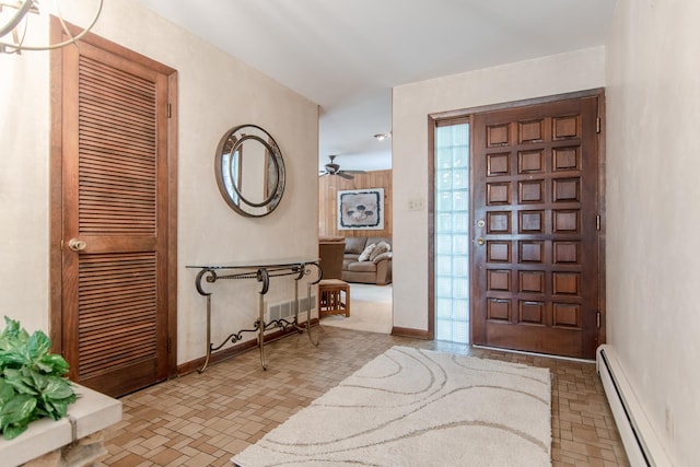 2458 E Cass St, Joliet, IL 60432 - entryway featuring baseboard heating, a ceiling fan, and brick patterned flooring