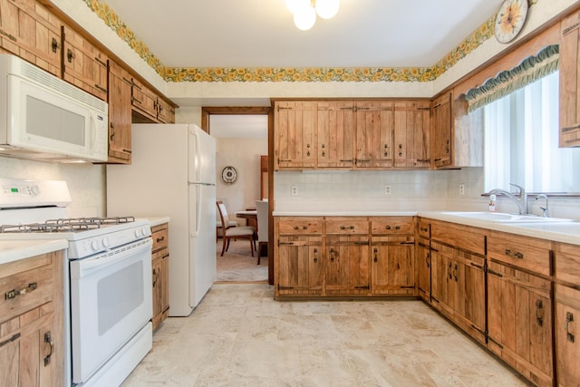 2458 E Cass St, Joliet, IL 60432 - kitchen with white appliances, light countertops, decorative backsplash, and brown cabinets