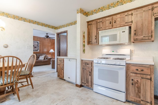 2458 E Cass St, Joliet, IL 60432 - kitchen featuring white appliances, light countertops, a ceiling fan, and brown cabinetry