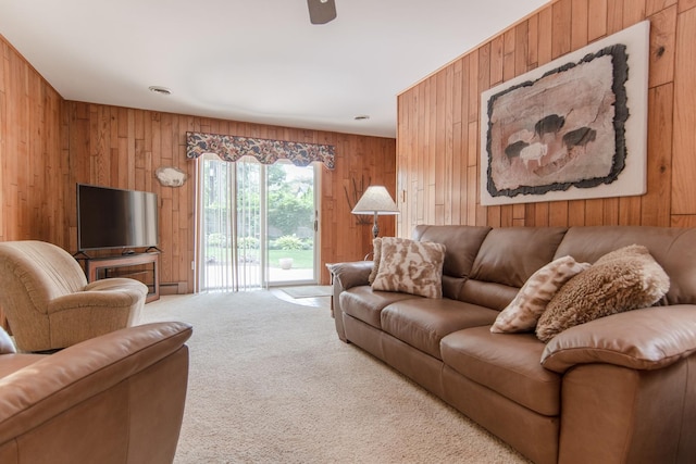 2458 E Cass St, Joliet, IL 60432 - living room with wood walls, carpet flooring, and ceiling fan