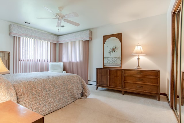 2458 E Cass St, Joliet, IL 60432 - bedroom featuring light carpet, a closet, ceiling fan, and a baseboard heating unit
