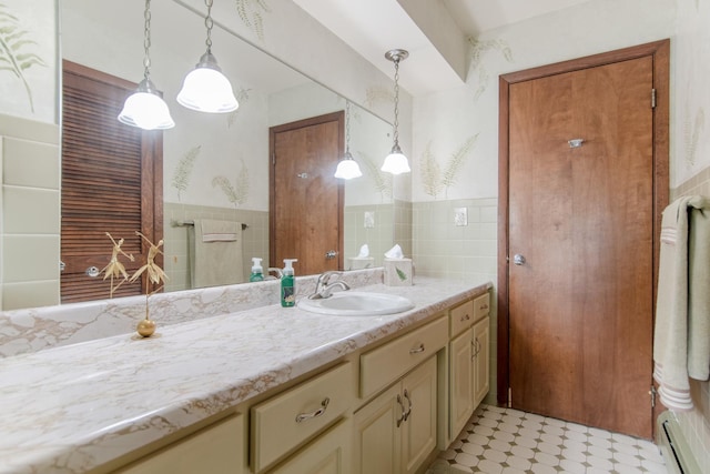 2458 E Cass St, Joliet, IL 60432 - bathroom with a baseboard radiator, vanity, tile patterned floors, tile walls, and a wainscoted wall