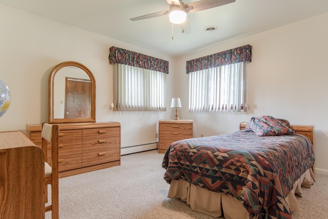 2458 E Cass St, Joliet, IL 60432 - carpeted bedroom featuring baseboard heating and a ceiling fan