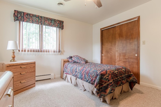 2458 E Cass St, Joliet, IL 60432 - bedroom featuring a baseboard heating unit, light carpet, a closet, and a ceiling fan