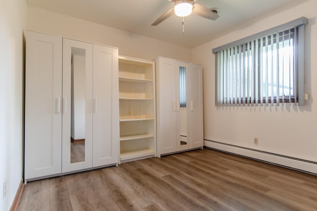 2458 E Cass St, Joliet, IL 60432 - unfurnished bedroom featuring wood finished floors, a baseboard radiator, and ceiling fan
