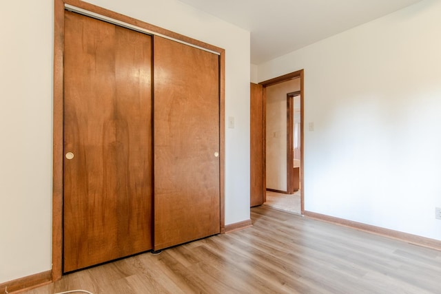 2458 E Cass St, Joliet, IL 60432 - unfurnished bedroom featuring light wood finished floors and a closet