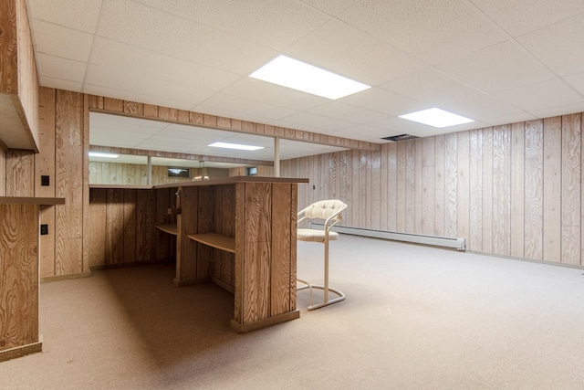 2458 E Cass St, Joliet, IL 60432 - finished basement featuring a baseboard radiator, a drop ceiling, wooden walls, and carpet