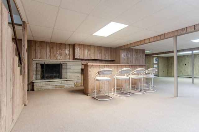 2458 E Cass St, Joliet, IL 60432 - indoor dry bar featuring wood walls, carpet, a drop ceiling, a fireplace, and a baseboard heating unit