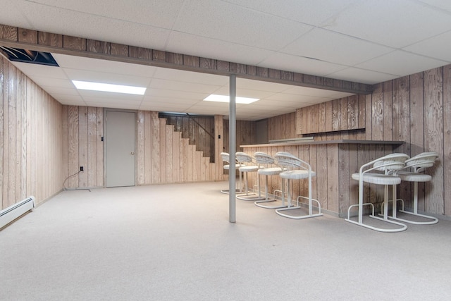 2458 E Cass St, Joliet, IL 60432 - indoor dry bar with a paneled ceiling, wood walls, carpet flooring, stairway, and a baseboard heating unit