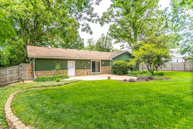 2458 E Cass St, Joliet, IL 60432 - back of house with stone siding, a patio area, a gate, and roof with shingles