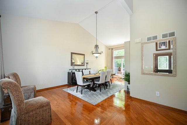 678 Larch Dr, Carol Stream, IL 60188 - dining room featuring wood finished floors and high vaulted ceiling