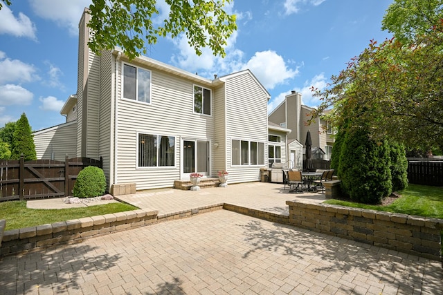 678 Larch Dr, Carol Stream, IL 60188 - rear view of house with a patio area, a chimney, and a gate