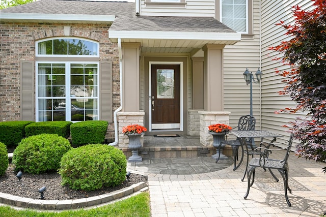 678 Larch Dr, Carol Stream, IL 60188 - view of exterior entry featuring roof with shingles and stone siding