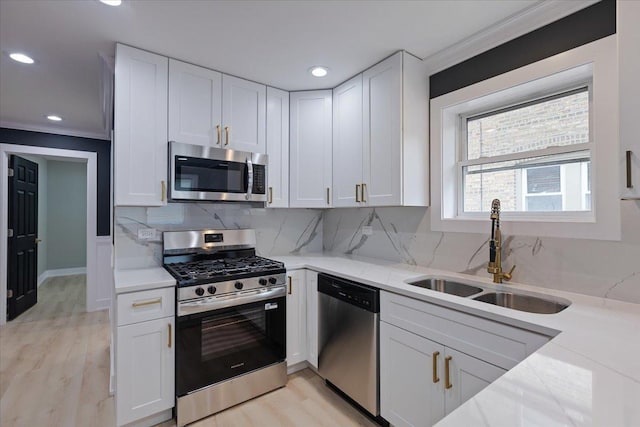 10011 S Princeton Ave, Chicago, IL 60628 - kitchen with appliances with stainless steel finishes, crown molding, white cabinetry, light wood finished floors, and tasteful backsplash