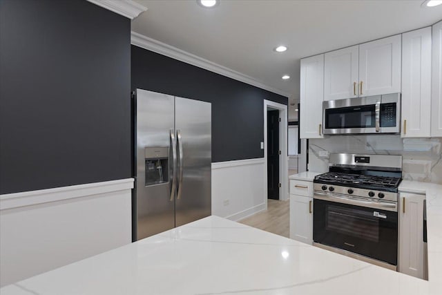 10011 S Princeton Ave, Chicago, IL 60628 - kitchen featuring appliances with stainless steel finishes, crown molding, recessed lighting, white cabinets, and tasteful backsplash