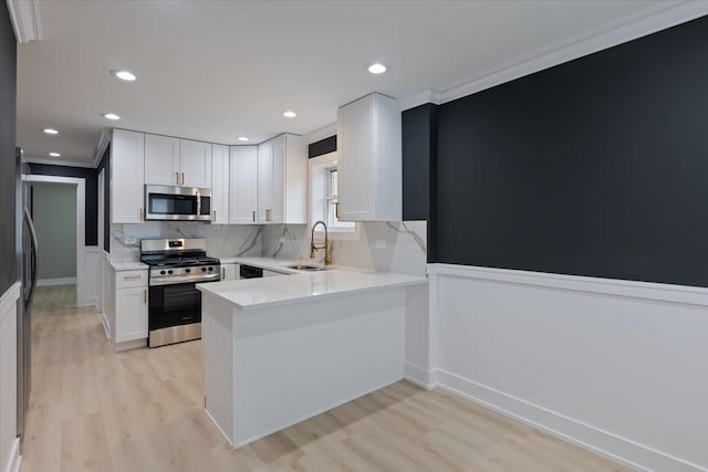 10011 S Princeton Ave, Chicago, IL 60628 - kitchen featuring stainless steel appliances, light wood-type flooring, crown molding, white cabinetry, and recessed lighting