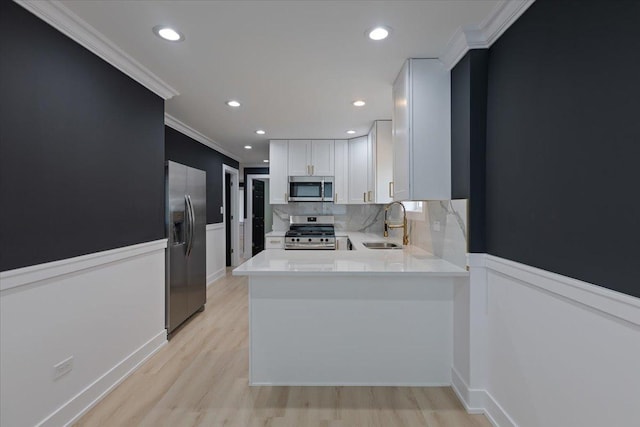 10011 S Princeton Ave, Chicago, IL 60628 - kitchen featuring stainless steel appliances, crown molding, wainscoting, light countertops, and backsplash